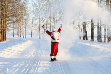 Santa in the winter field. Santa magical fog is walking along the field. Santa on Christmas Eve is carrying presents to children in a red bag.