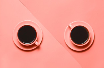 Two cups of coffee on minimal Two cups of coffee on minimalistic living coral color of the year...