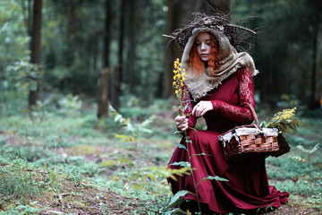 The red-haired witch holds a ritual with a crystal ball