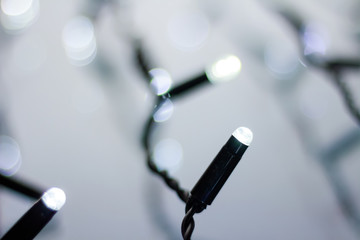 Naklejka premium Christmas lights blurred background with bokeh. New Year glowing garland