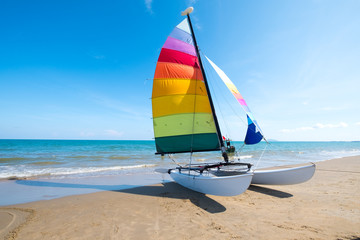 Colorful sailboat on tropical beach in summer.