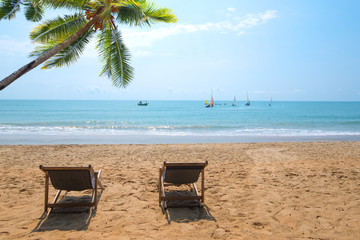 Fototapeta na wymiar Couple beach chair on tropical beach.