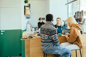 Coffee shop bar counter cafe restaurant service people relaxation concept. Female barista with two...