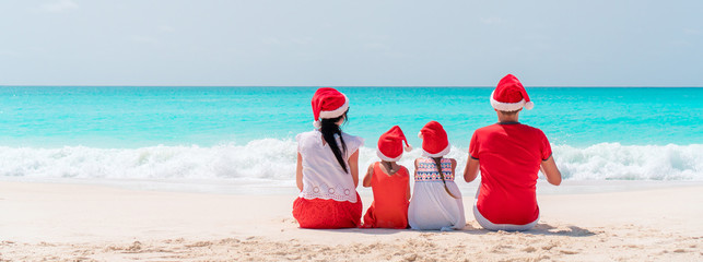 Happy family on the caribbean beach celebrating Christmas vacation © travnikovstudio