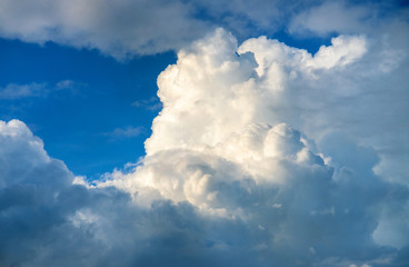 Blue sky and white cloud in sunlight. Cloudscape photo background. Romantic skyscape with fluffy...