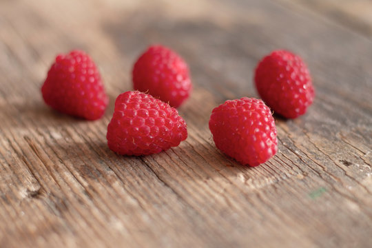 Fresh healthy raspberries on wooden table