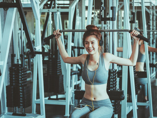 Fototapeta na wymiar Fitness woman with headphone and smart phone in gym