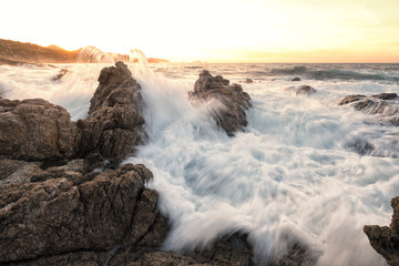 Sunset and rough sea on the coast of Corsica