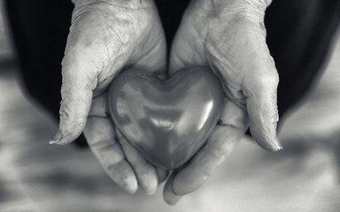 elder woman holding heart