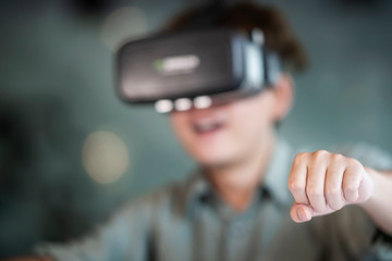 Young male software programmer testing a new games app with 3d virtual reality glasses