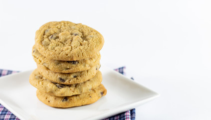 Close up chocolate cookies on white plate and white blackground.