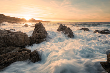 Sunset and rough sea on the coast of Corsica