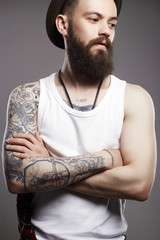 Hipster boy with tattoo. handsome man in hat