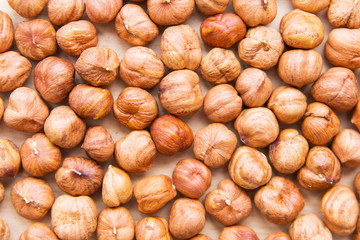 hazelnuts on light wooden background. Texture of hazelnuts. Nuts on the table
