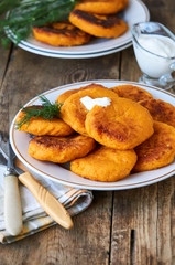 Carrot cutlets with sour cream and fresh dill on a plate 