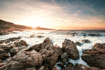 Fototapeta na wymiar Sunset and rough sea on the coast of Corsica