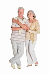 Portrait of senior couple hugging on white background