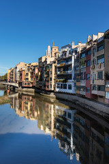 Fototapeta na wymiar Girona famous landmark river facade houses with water reflection