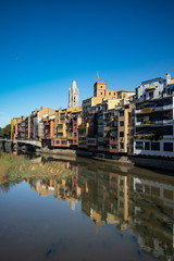 Fototapeta na wymiar Girona famous landmark river facade houses with water reflection