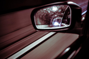 Left mirror car on a dark tunnel
