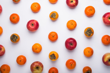 Apples, mandarins, and persimmon pattern, top view