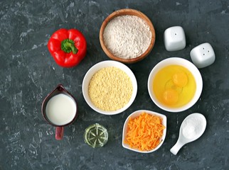 Ingredients for cooking corn unleavened bread: wheat flour, red peppers, corn flour, oil, salt, pepper, grated cheddar cheese, baking powder, eggs, milk or buttermilk.
