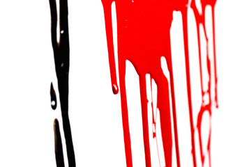 Close-up of the black and red flowing paint isolated on white background