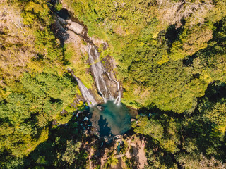 Aerial view of waterfall with clear water in tropical jungle, Bali