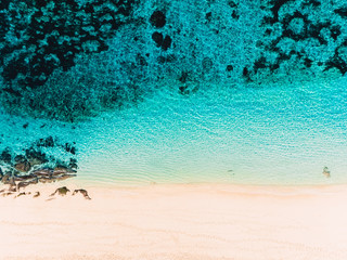 Tropical beach with crystal blue sea and sand. Top view background. Aerial view