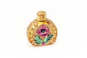 Vintage perfume bottle in gold filigree isolated on white background