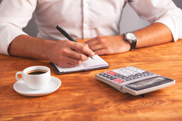 Fototapeta premium businessman coffee calculator notebook