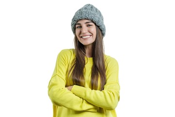 Young beautiful woman in yellow sweater and gray big loop knitted beanie hat, hands folded, looking at the camera on white isolated background