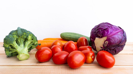 Vegetables for health. Foods concept Purple cauliflower, cucumber, carrot, tomato, Broccoli on wood white background. Copy space for design.