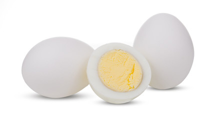 Two boiled whole and sliced eggs isolated on white background
