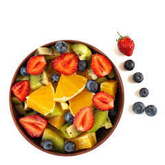 Bowl of healthy fresh fruit salad isolated on white background. Top view