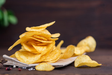 Potato chips in bowl on a wooden background, Selective focus