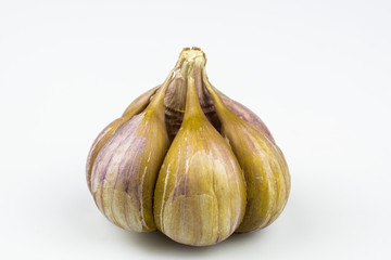 A Head of garlic light-brown color isolated on a white background.