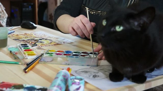 Black cat on the artist's Desk