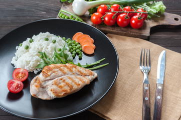 Chicken fillet on plate with rice