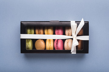 Gift box with assortment of French macaron cookies, top view