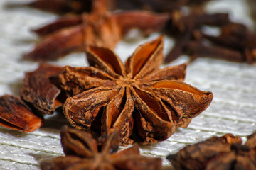 Anise stars aromatic asian spices on a rustic vintage background