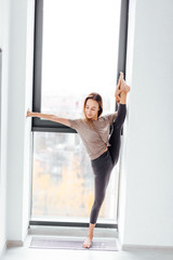 athletic girl concentrated on air split. full length photo.dancer doing splits in the modern room