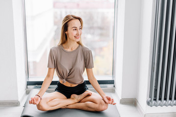 young pretty woman rejoicing at yoga classes. full length photo. copy space . full length photo