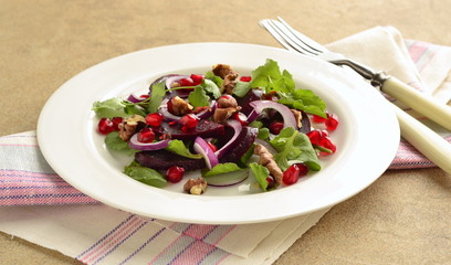 Beetroot salad with arugula, walnuts and pomegranate seeds