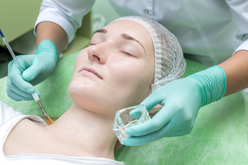 Naklejka premium Beauty salon, facial peeling mask.