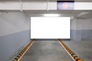 indoor car parking and empty white billboard .Blank space for text and images.