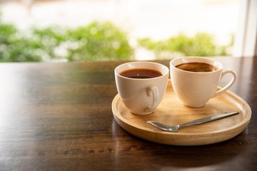 Coffee cup in wooden tray in vintage style cafe