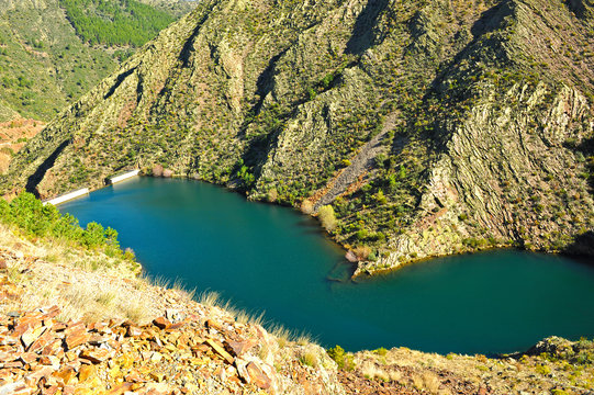 Concrete dam of Maja Robledo reservoir in the river Hurdano. Las Hurdes is a mountainous region of the north of the province of Cáceres in Extremadura, Spain.