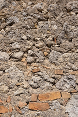Wall with basalt blocks and bricks.