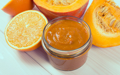 Homemade preserves. Pumpkin jam on a wooden background.
